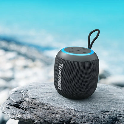 Tronsmart T7 Mini: 15W, IPX7, hasta 18 h (LED off), TWS, luces rítmicas, BT 5.3, MicroSD y Aux-in. Compacto y potente para playa, ducha o viajes.